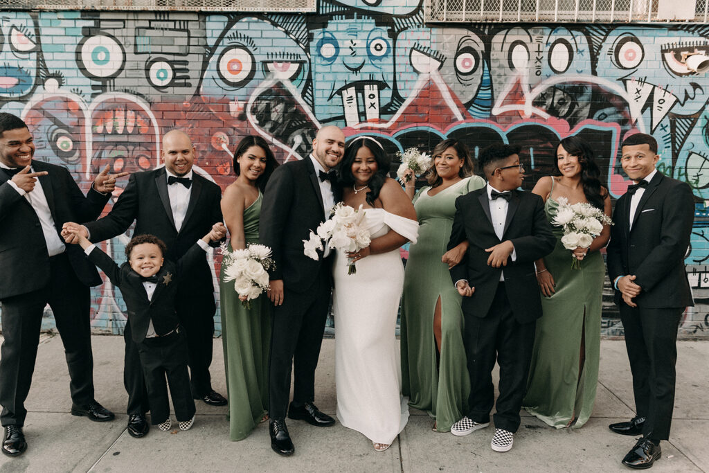 Wedding party group photo outside of the Syndicated Movie Theatre and Bar in Bushwick Brooklyn, NY.