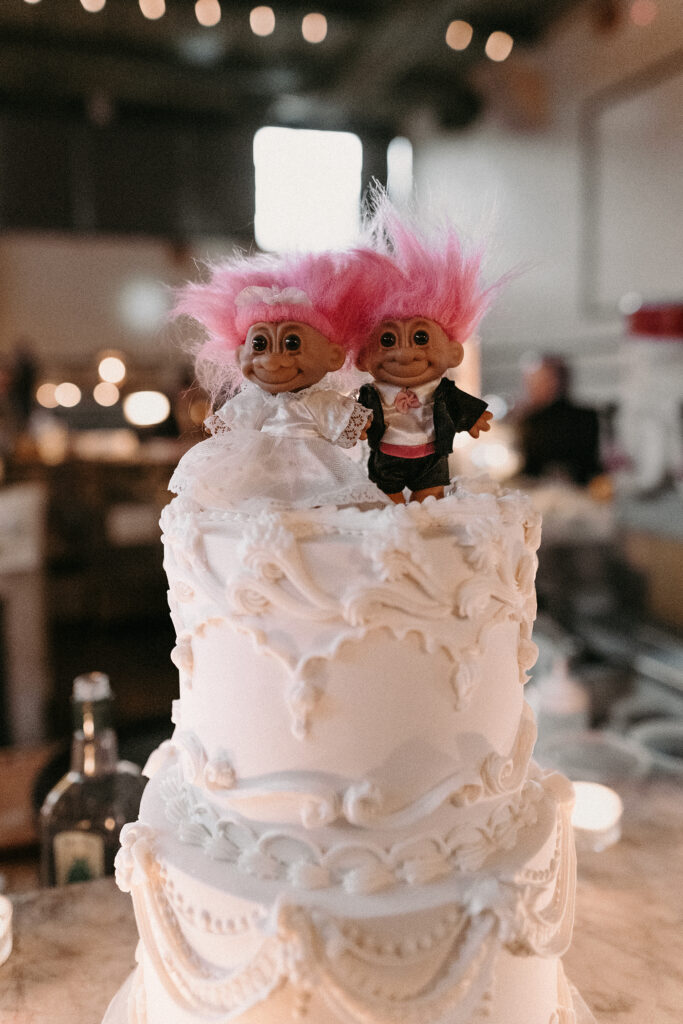 Close up of a trolls wedding cake topper at a movie theatre wedding in Brooklyn, NY