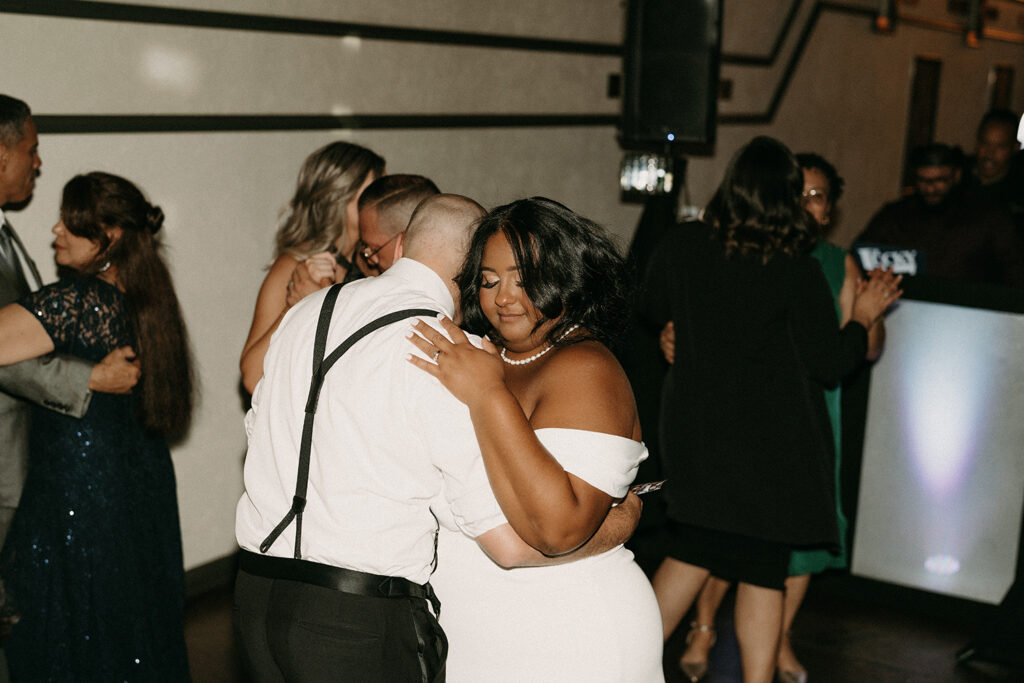 Bride and groom sharing a sweet hug on the dance floor during the reception.