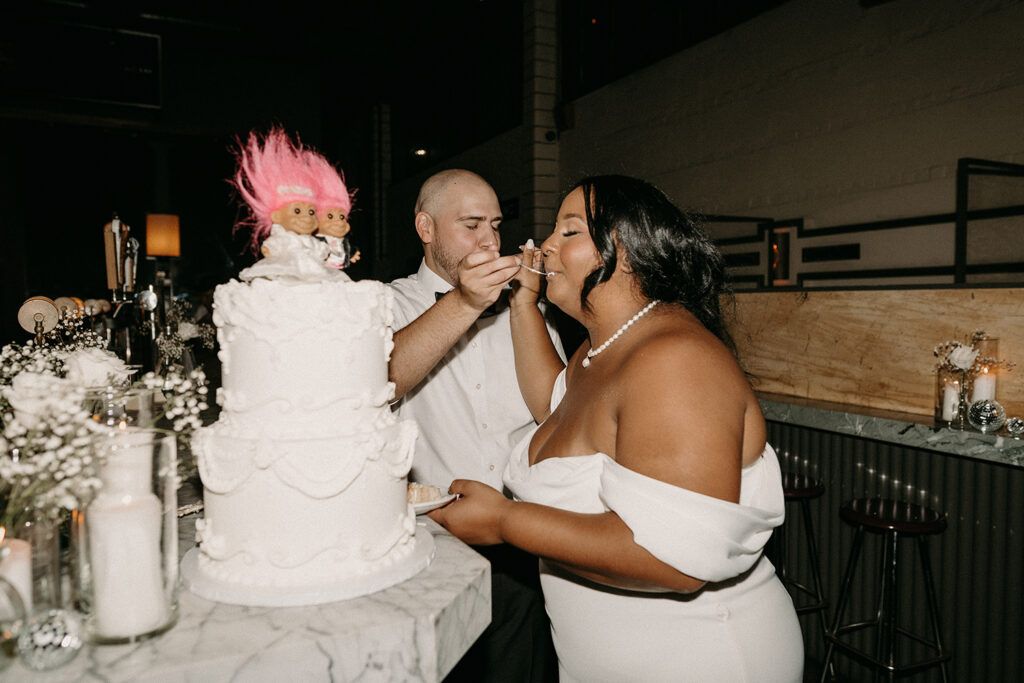 Bride and Groom sharing a bite of their wedding cake.