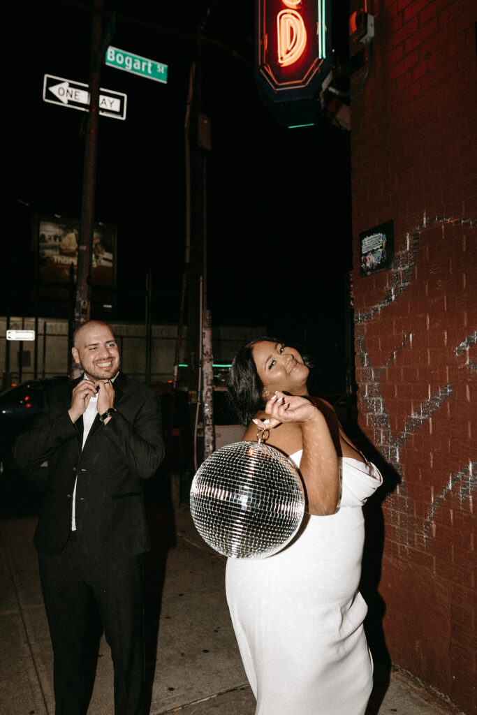 Direct flash photo of a bride and groom with the neon movie theatre sign at Syndicated in Bushwick Brooklyn, NY.