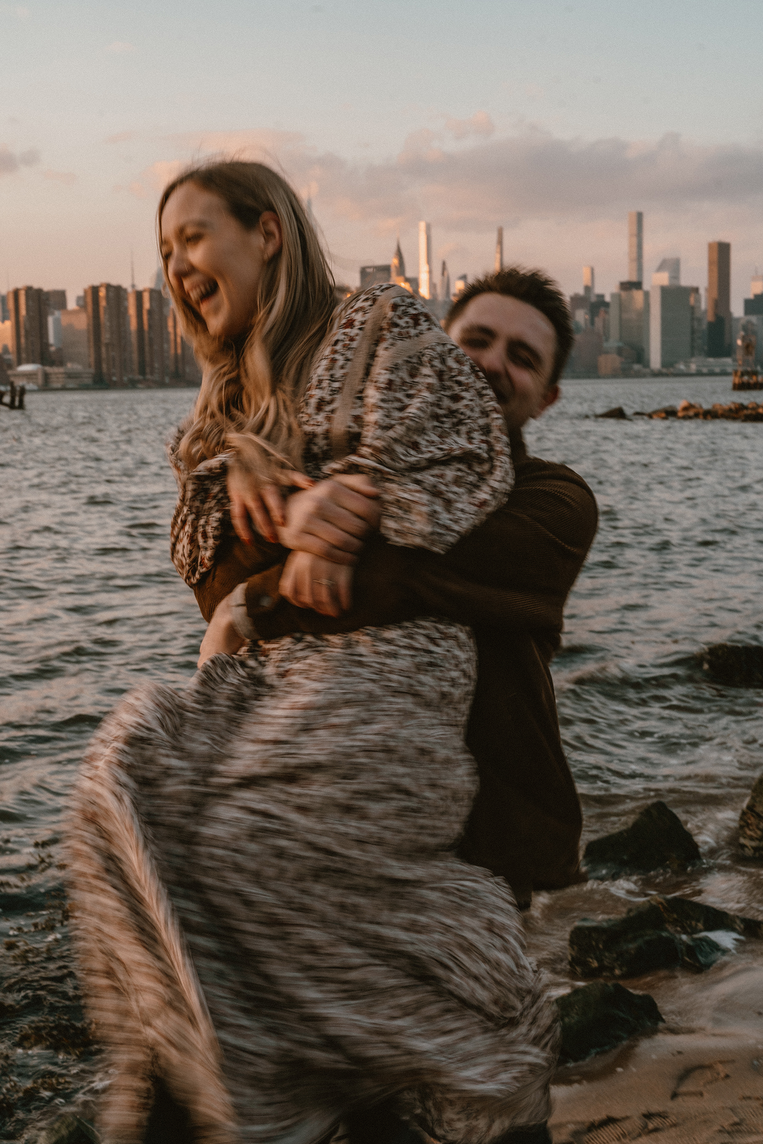 Engagement photos during blue hour looking out over the NYC skyline.