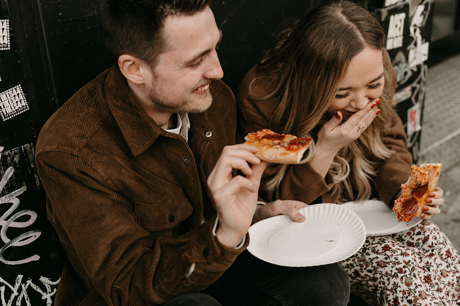 A couple eating vegan pizza during their engagement photoshoot in Williamsburg.