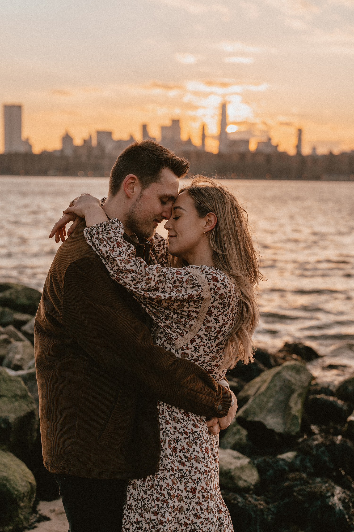 Engagement photos looking out over the NYC skyline during golden hour.