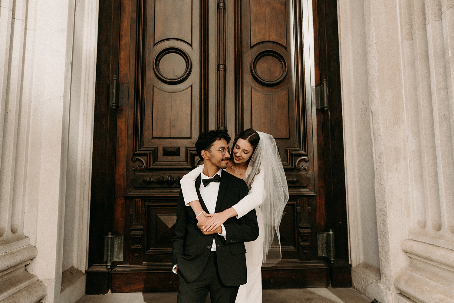 New York City Elopement. Couple in wedding attire hugging outside City Hall.