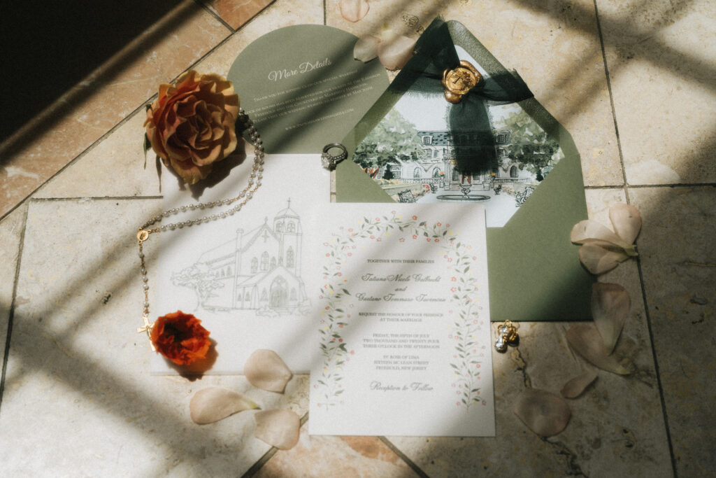 A flat lay of details like the wedding invitations suite and wedding rings placed on the floor in the shadow patterns of a nearby window.