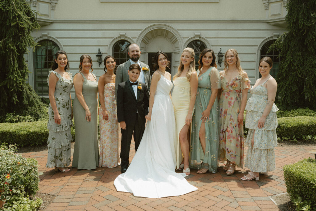 A bride and her wedding party outside the ashford estate with coordinating shades of yellow and greens.