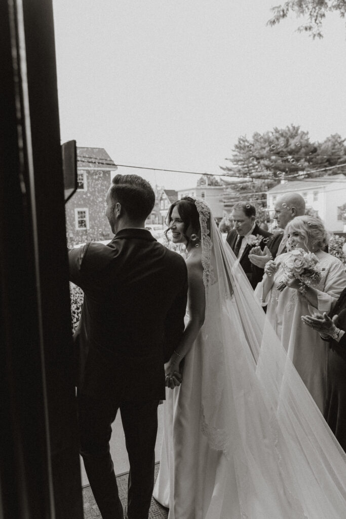 A bride and groom leave the church after their cathedral ceremony.