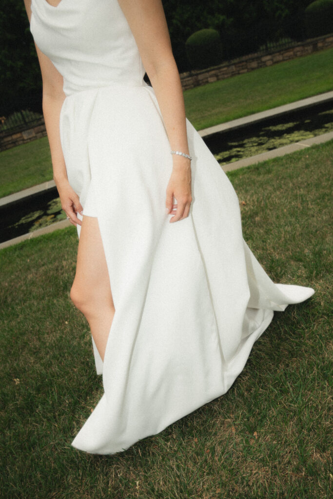 A direct flash moment highlighting the brides flowing dress fabric and high slit.