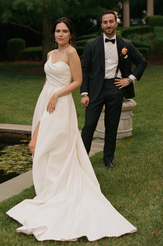 On 35mm film a bride poses in a luxurious garden with her husband at the Ashford Estate.