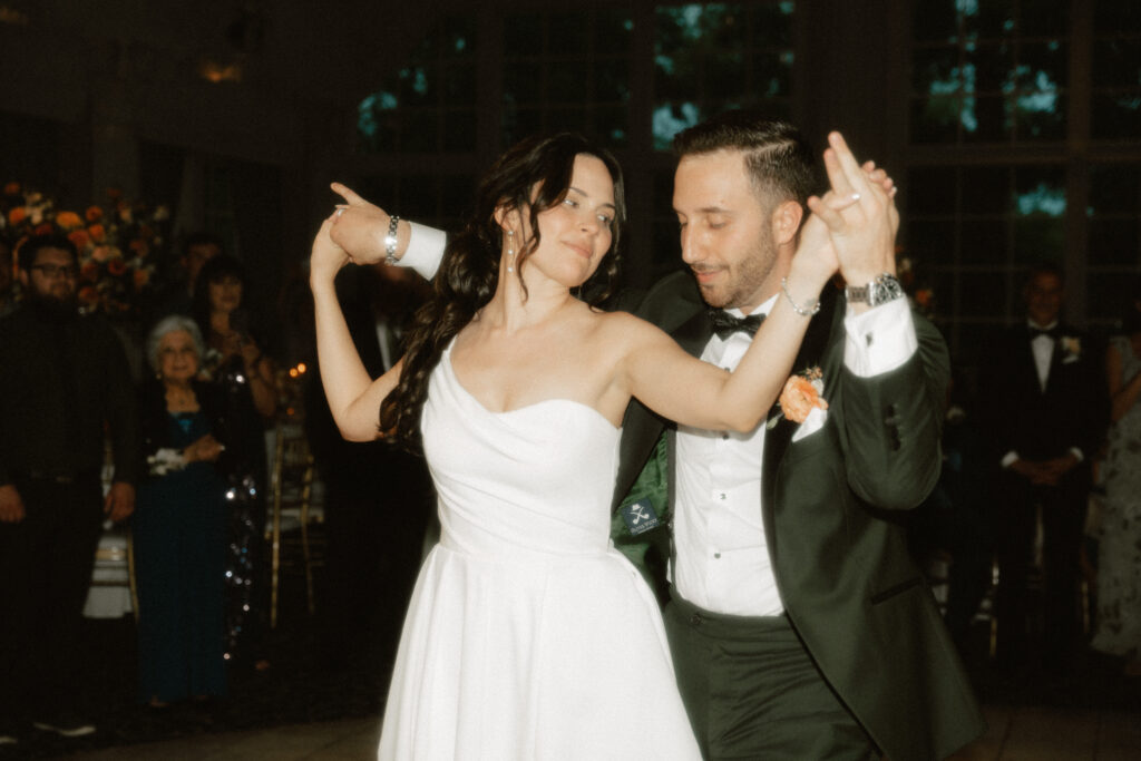 A romantic moment during a choreographed first dance at a luxury garden wedding.