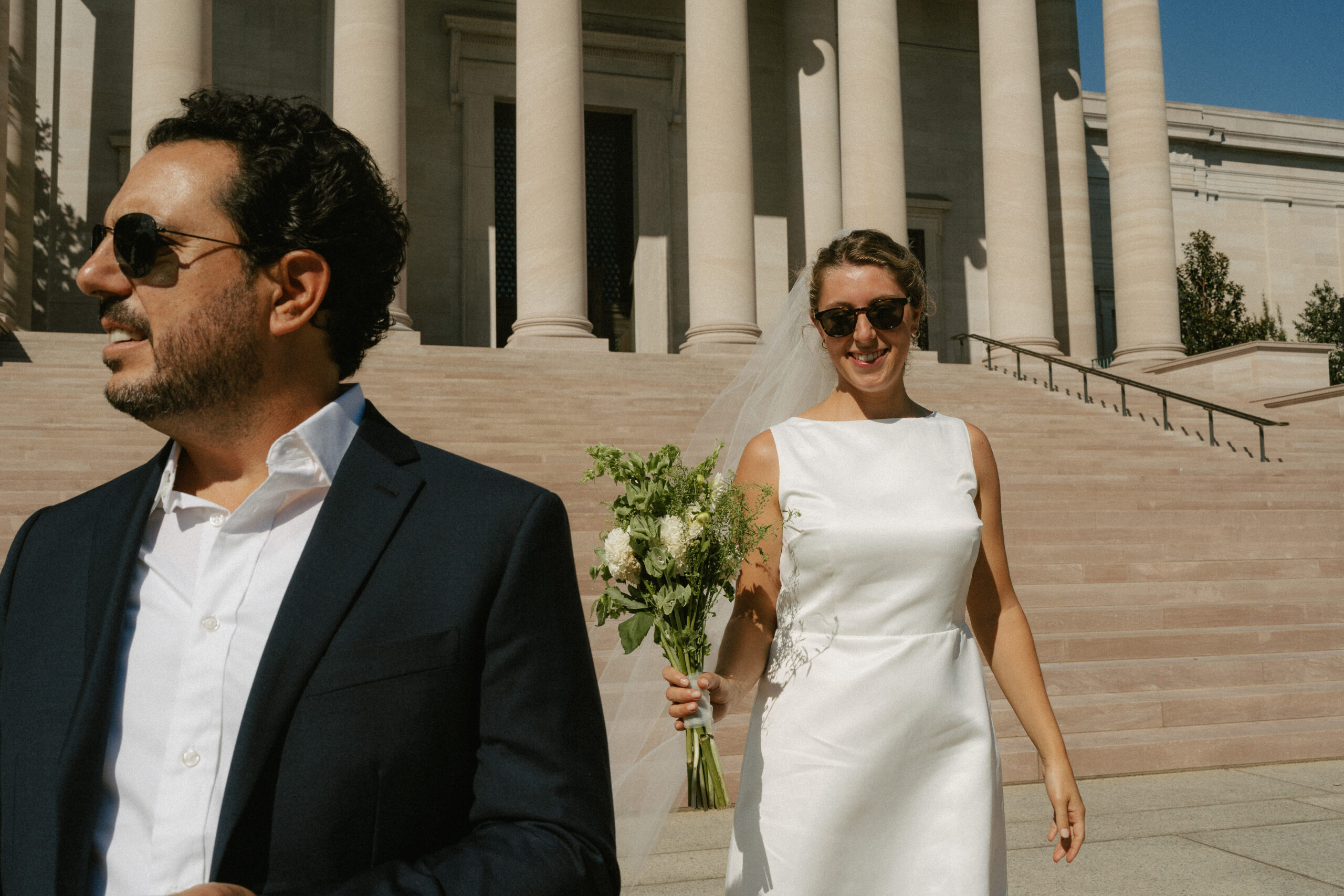 bride following groom down stairs of Library of Congress front steps