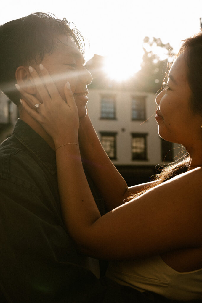Sun Flair embrace of engaged couple in NYC during golden hour