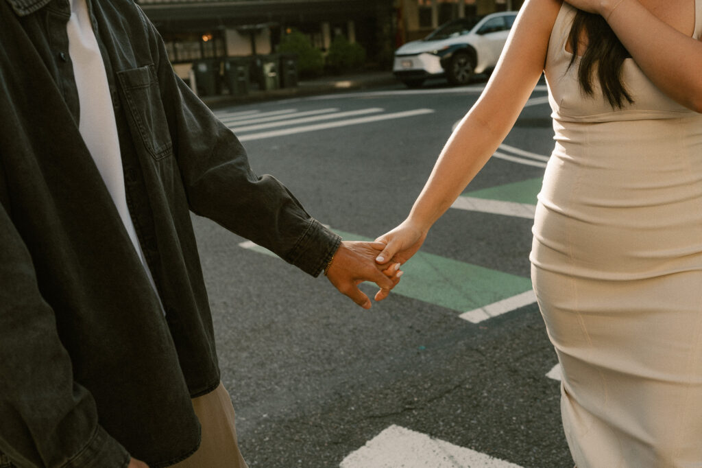 close up of couple holding hands in the sunrise shine of early morning in NYC