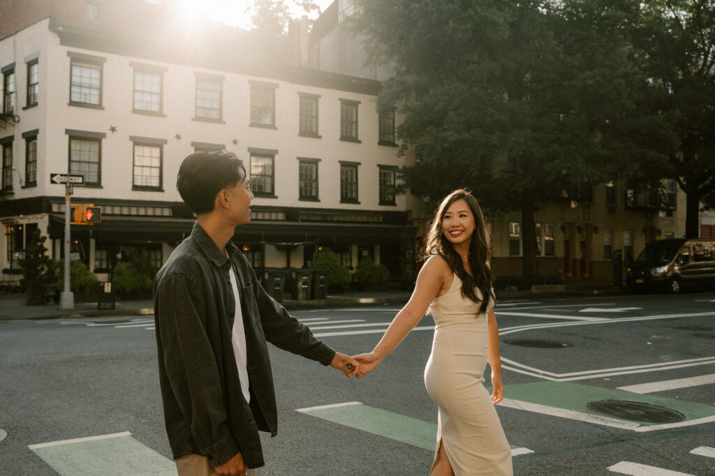 Flirty couple in the warm glow of quiet west village streets