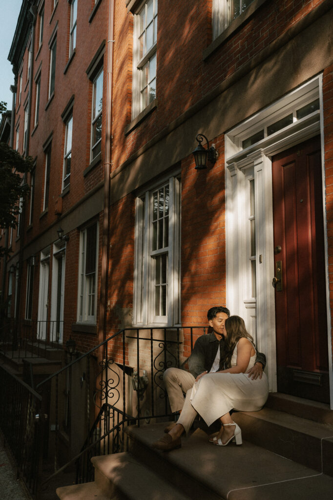Natural light forming shadows on brownstone townhome around the engaged couple shot in West Village