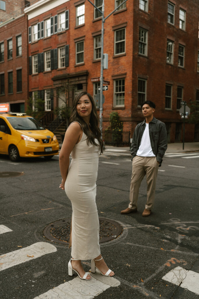 NYC posed in street cross walk shows engaged couple's sass and elegance