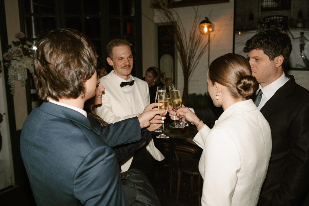 champagne toast to the married couple with a back shot of brides updo bun twist