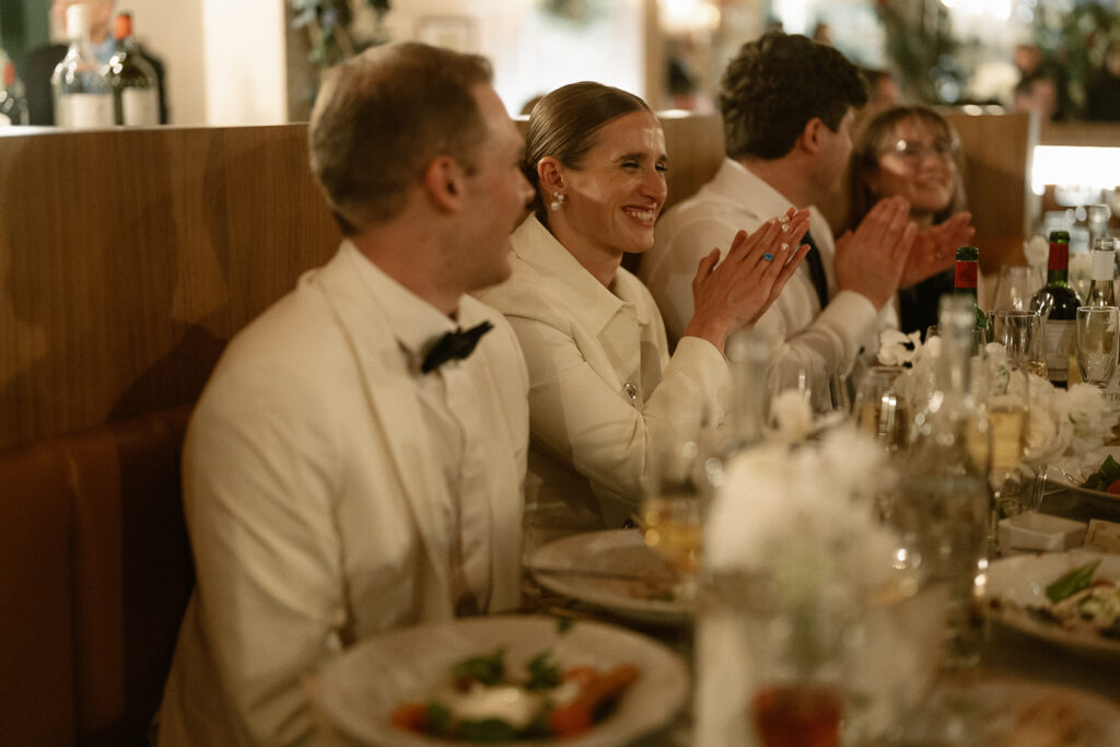 clapping over dinner and while listening to well wishes being toasted 