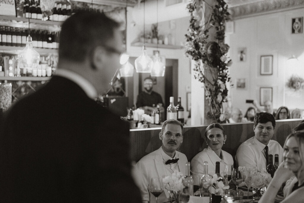 black and white image of dinner with newly weds