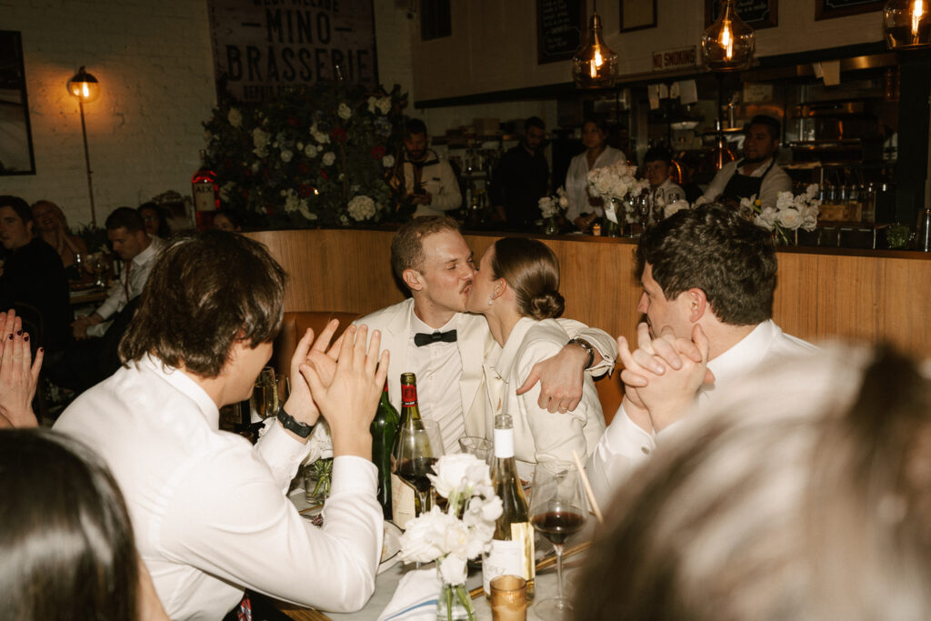 Newlyweds kiss during toast