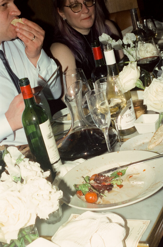 shot of fully enjoyed dinner plate surrounded by evidence of merriment