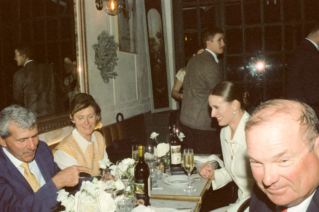 Bride and Grooms parents seated for hybrid elopement reception dinner