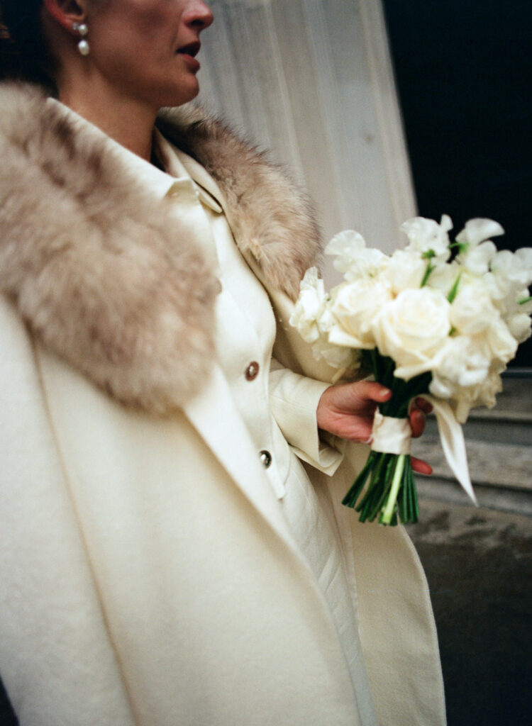 Close up of fur shrug found at an estate sale added to off white pea coat to upscale bridal look