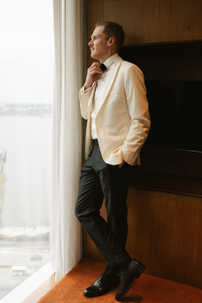 Groom adjusting bow tie at the Standard Hotel
