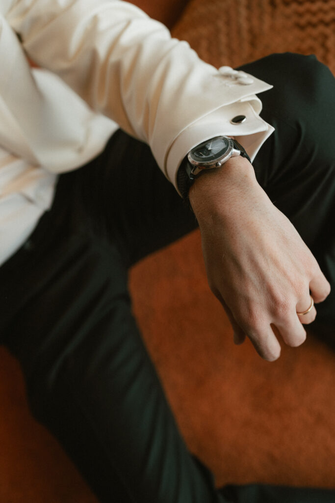 Groom detail shot of watch and cufflink 