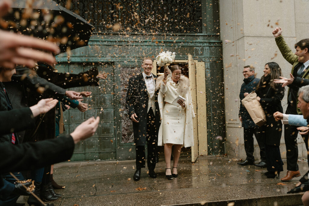 bride and groom greeted by closest friends and family as they exit city hall in Manhattan