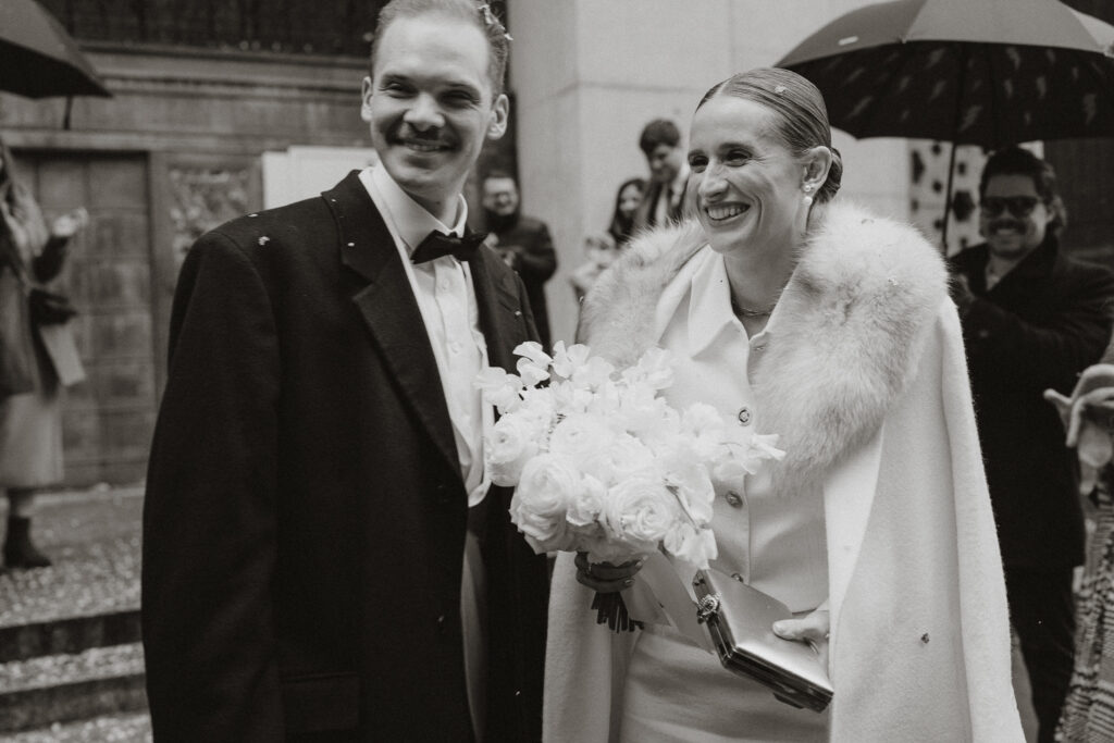 black and white image of bride and groom after quick vow exchange in the city