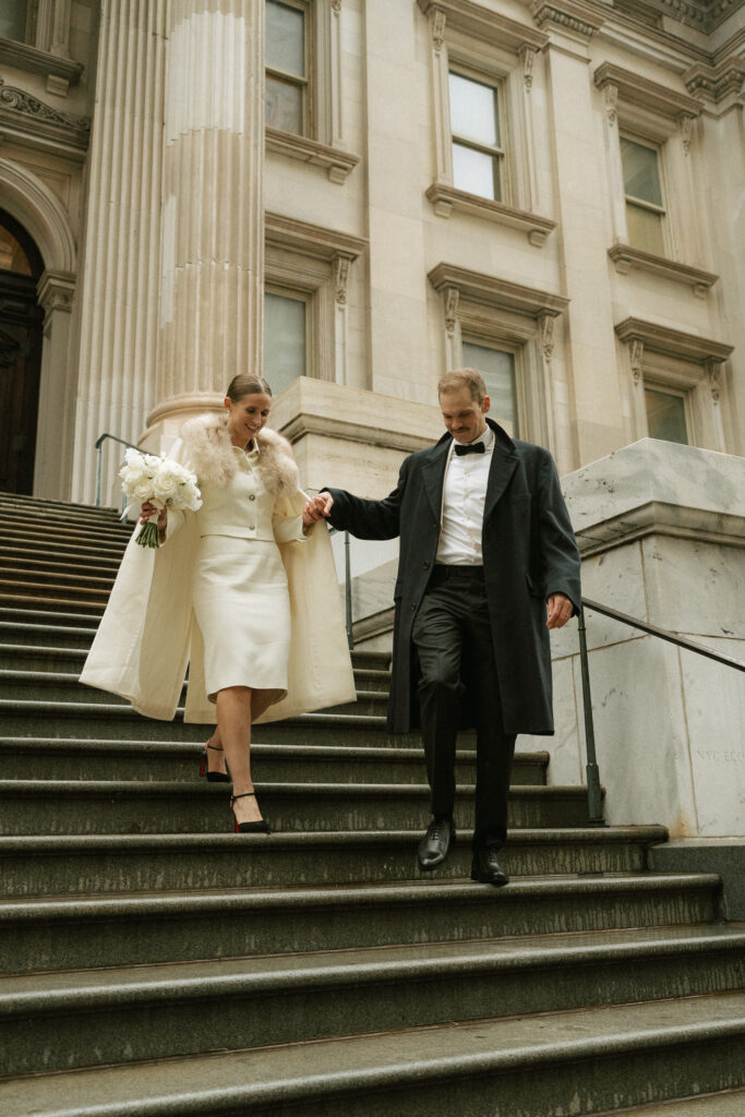 married couple walking down steps after exchange of vows