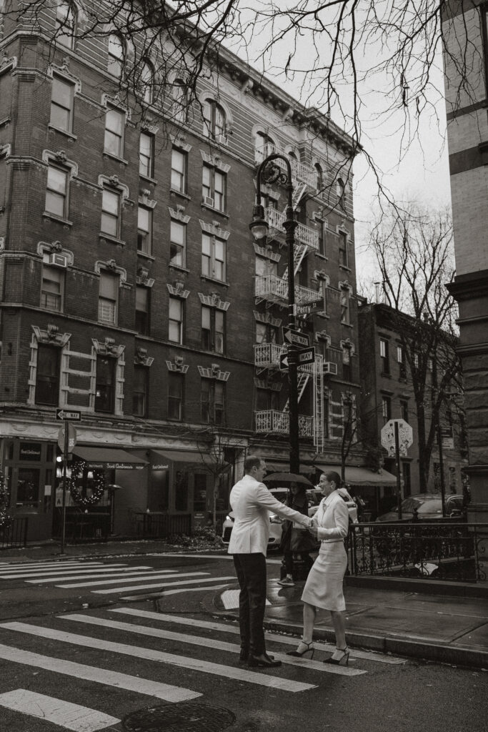 iconic New York street crossing with just married couple coming from City Hall