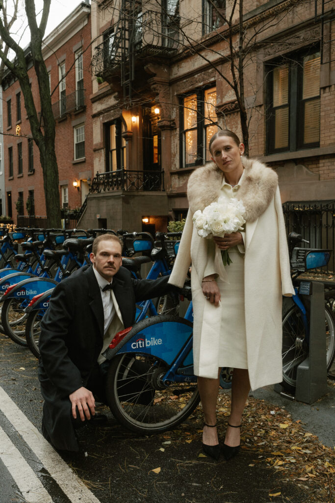 serious facial expressions on a just married couple is offset by row of Citi bikes 