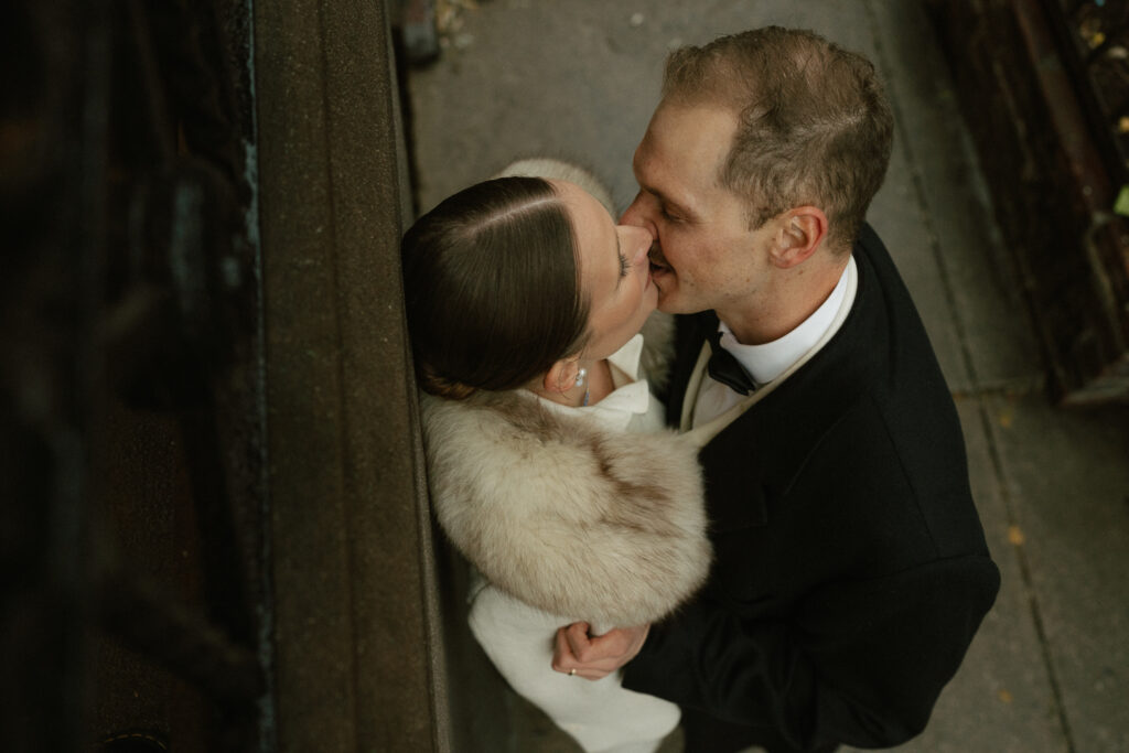 photographer above couple catches a romantic kiss before the cocktail hour at St. Tropez in Manhattan NY