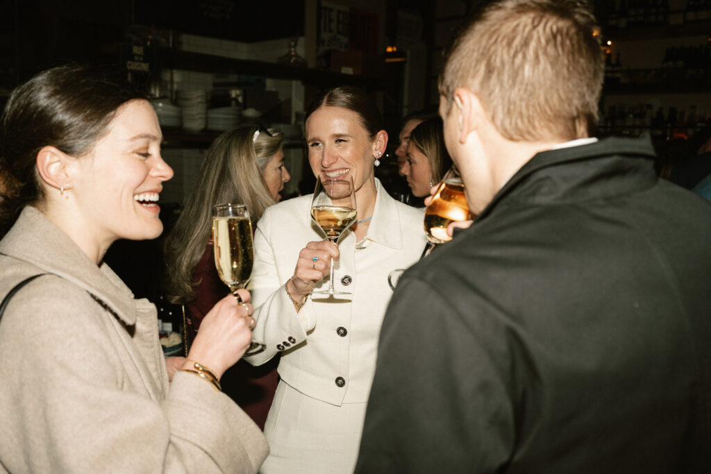 guests at cocktail hour talking with bride and groom