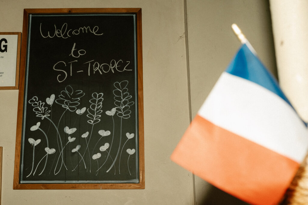 St Tropez welcome sign with a French flag in the shot