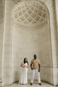 A marble framed photo of engaged couple in the architectural steps of NY library