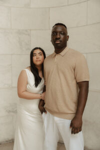 Neutral fashion statement by couple surrounded by neutral colors of marble forming exterior of NY library