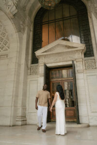 Exterior shot of NYPL with engaged couple