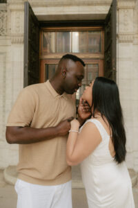Exterior doors of library form background for elevated engagement shoot in New York