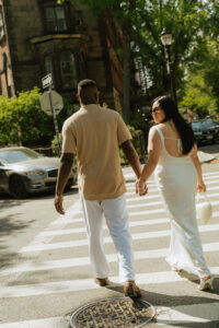 holding hands for engagement photos in NYC Crosswalk