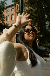 Bride to be sporting sun glasses and posing in hard light photo shoot