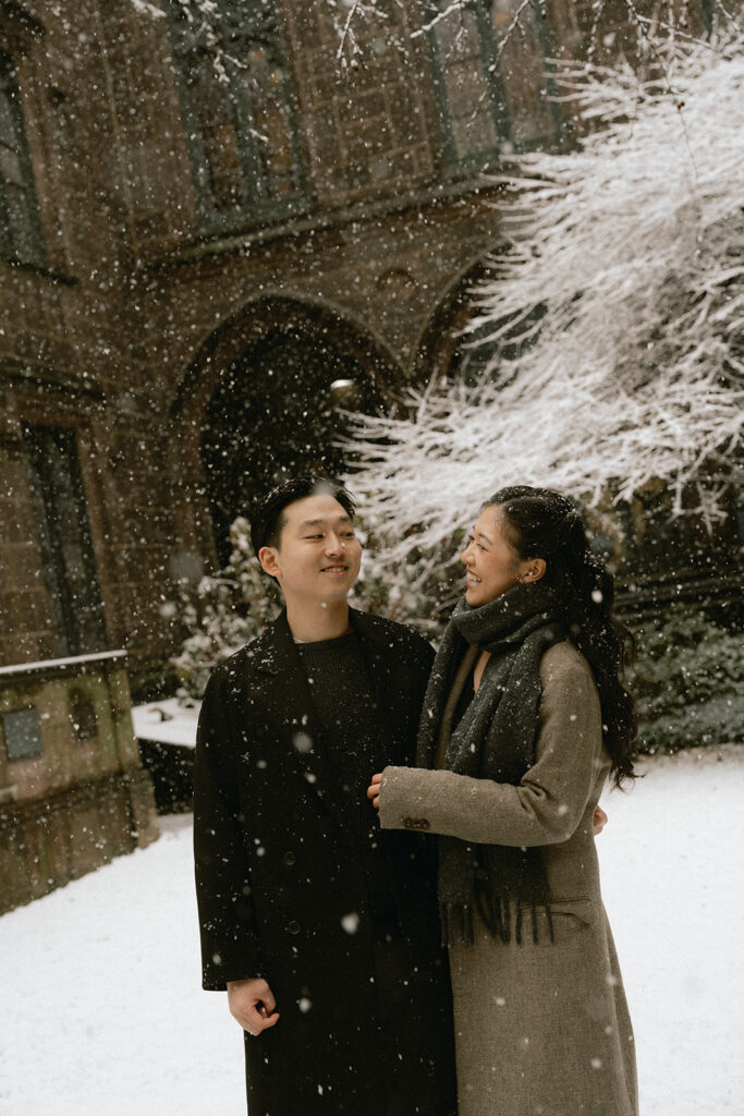 Snowy engagement photos in New York City with a cinematic style.
