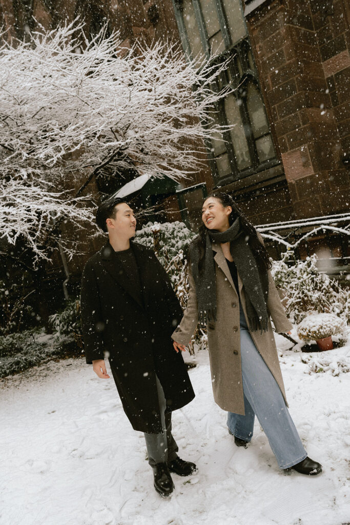 Snowy engagement photos in New York City with a cinematic style.