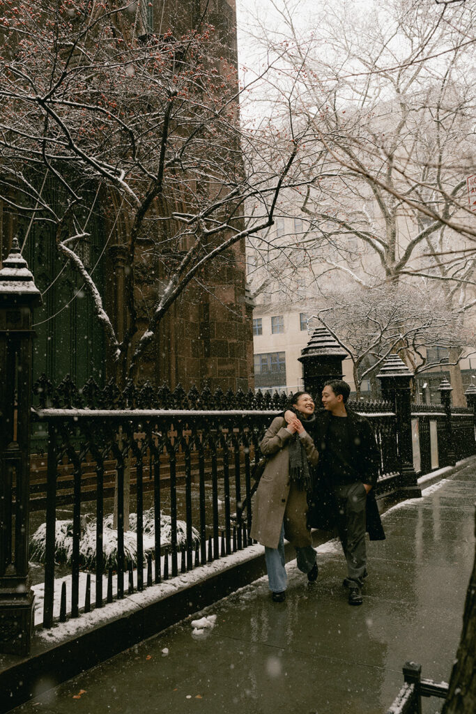 Snowy engagement photos in New York City with a cinematic style.