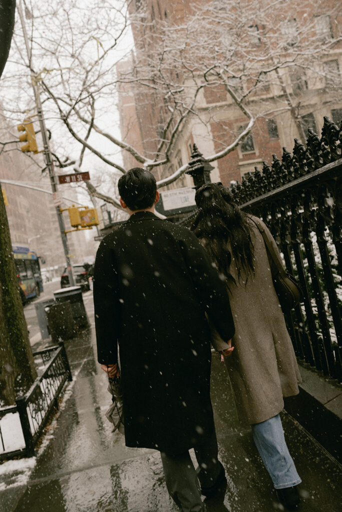 Snowy engagement photos in New York City with a cinematic style.