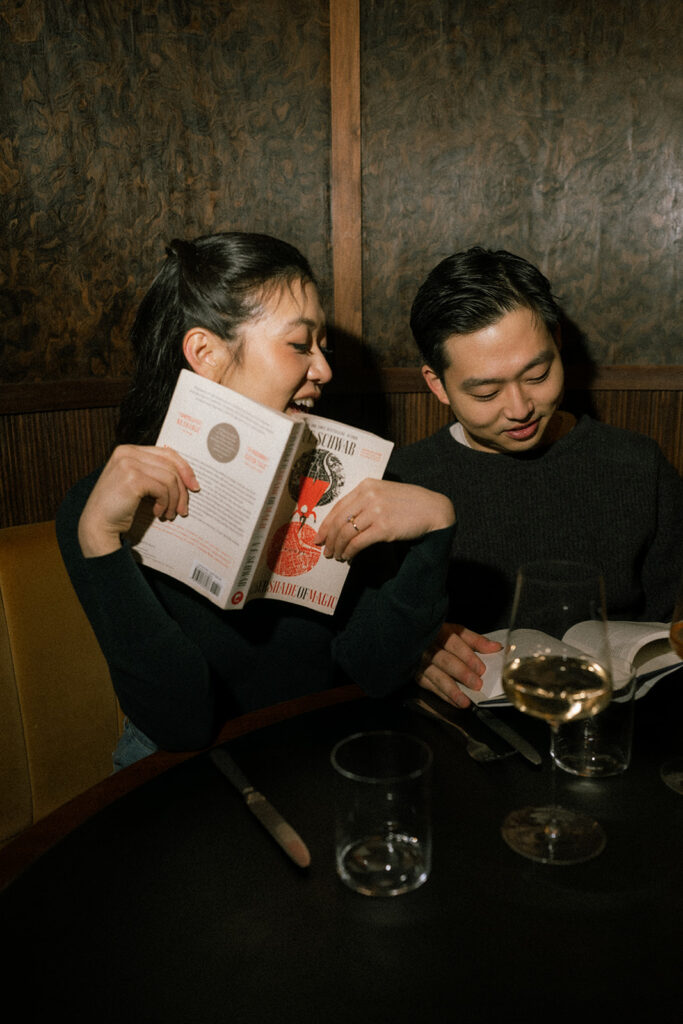 Indoor engagement photos at a wine bar with flash photography.