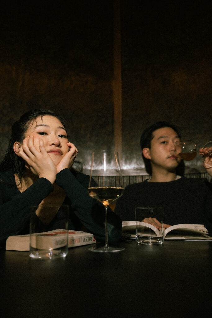 Indoor engagement photos at a wine bar with flash photography.